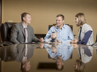 Financial advisor meeting with young couple and baby