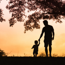 Dad and Child walking at sunset